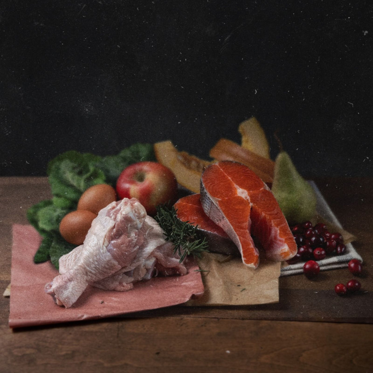 collection of raw chicken, salmon and fresh fruit and vegetables.